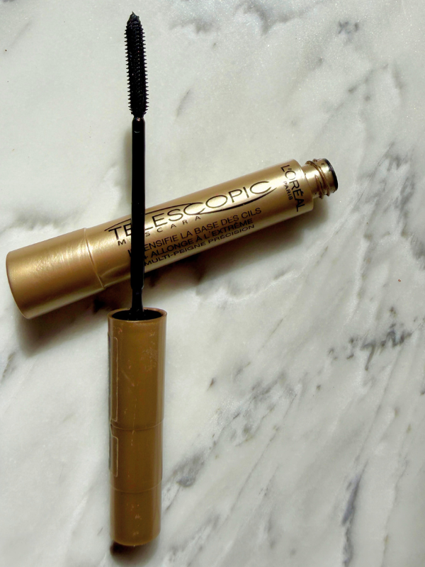 l'oreal telescopic mascara golden tube open on marble